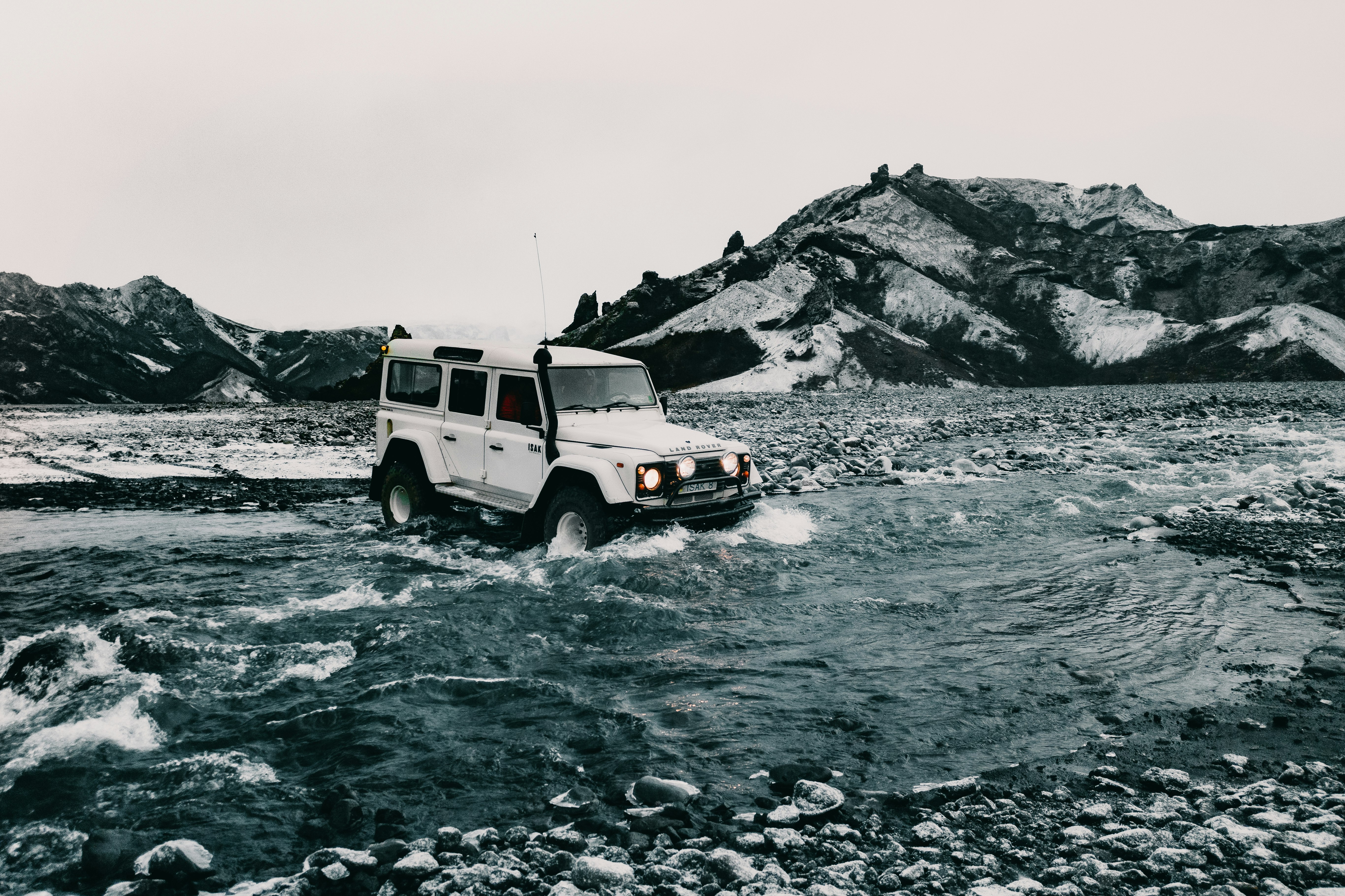 white suv on rocky road